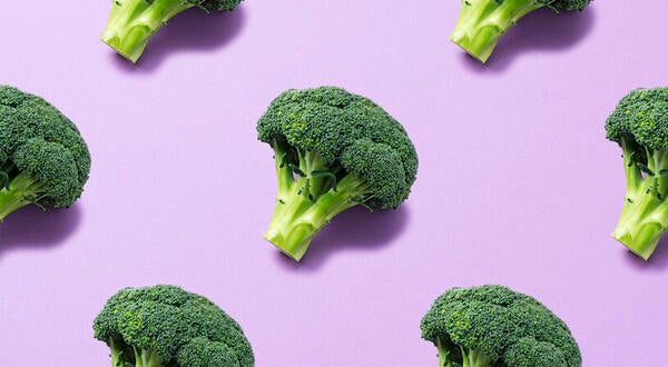 Broccoli in front of purple background